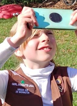 A Girl Scout photographs the sky to contribute to NASA science through GLOBE.